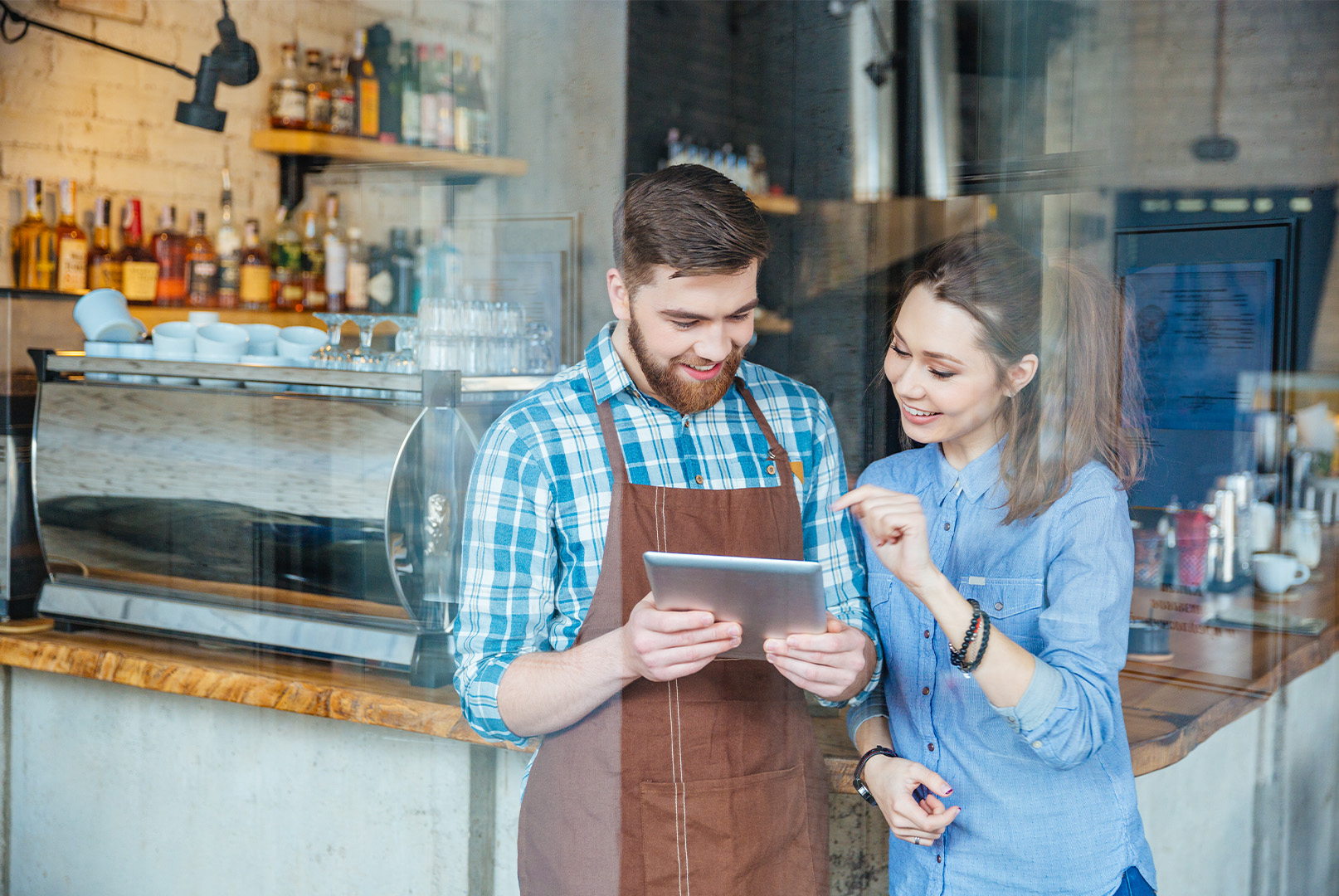 Two employees interacting with a tablet